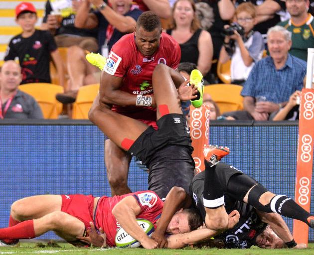James Tuttle scores the match-winning try for the Reds against the Sharks. Photo Getty