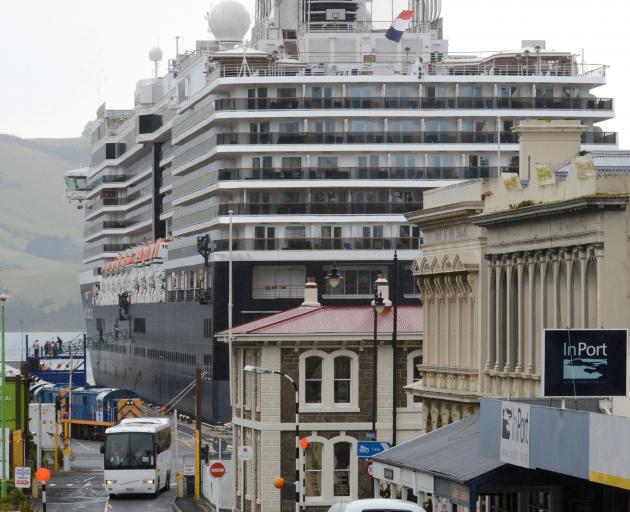 "Heritage buildings ... and dwarfed at the harbour's edge by the container terminal and its...