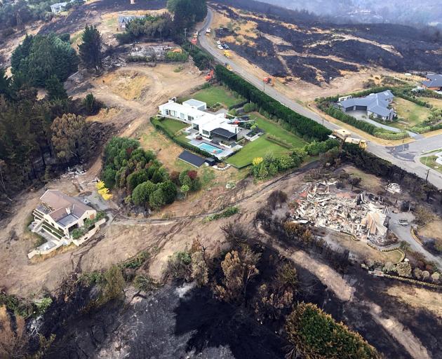 Surrounded by devastation, a helicopter fighting the Port Hills fire in Christchurch this week...