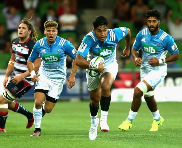 Rieko Ioane makes a break for the Blues against the Rebels in Melbourne last night. Photo: Getty...