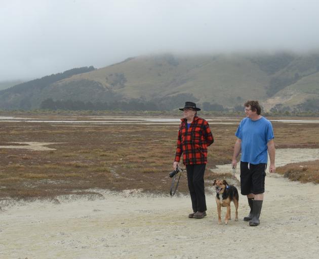 Adrian Hall (left) and Bradley Curnow, both Aramoana residents and members of the Aramoana Conservation Charitable Trust, say Aramoana's ecological treasures - including its salt marsh - could be disturbed by a restoration of the area's pilot wharf. Photo