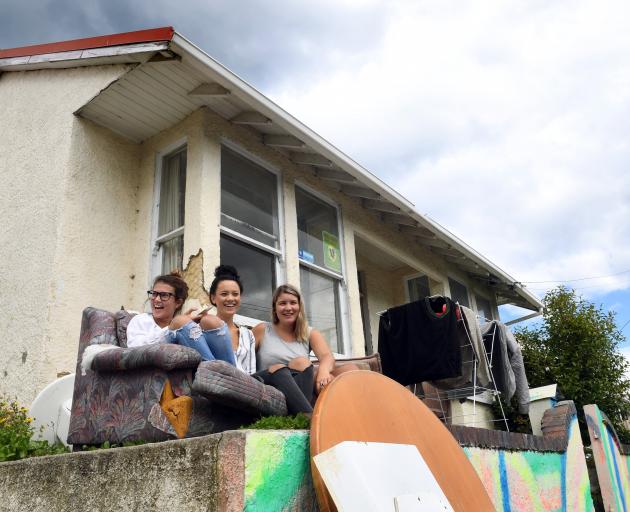 Visitor Kopare Williams (18 ,left) relaxes with two residents of a Hyde St flat, Aroha Raukaura (21, centre) and Cairah Pere (20), outside their flat on Tuesday. Photo by Stephen Jaquiery.