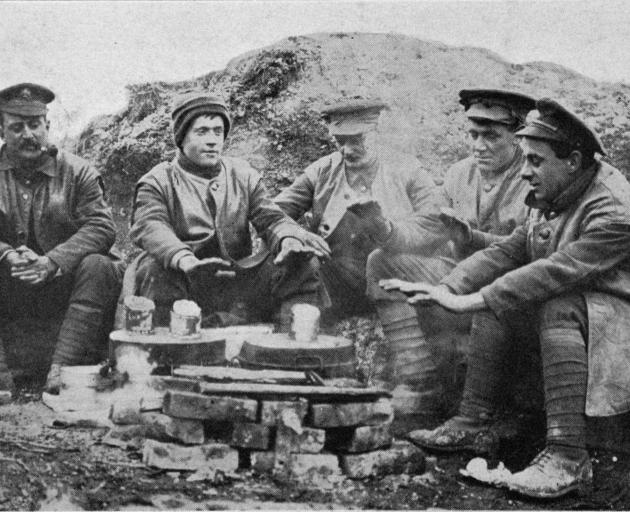British Tommies keeping warm while awaiting their lunch of pork and beans. - Otago Witness, 14.2...