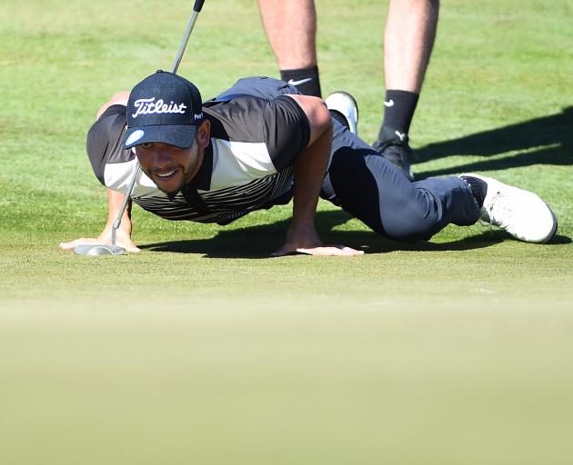 New Zealander Luke Toomey lines up a putt at The Hills in Arrowtown during the first round of the New Zealand Open yesterday. Photo from Photosport.