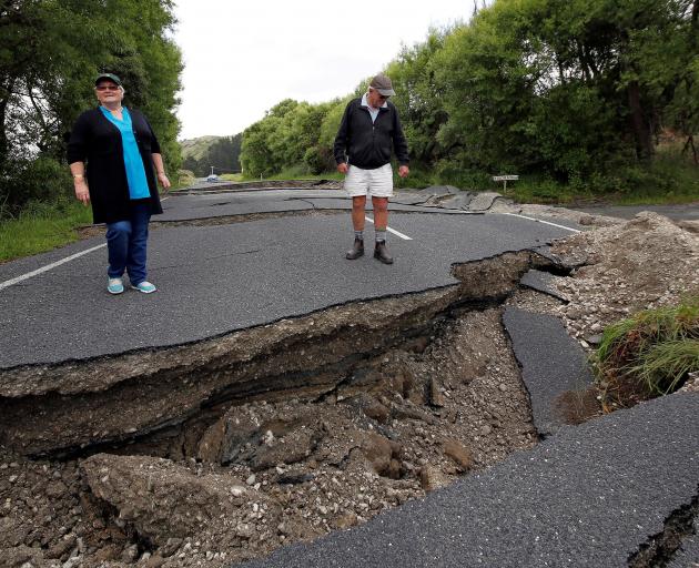 Chris and Viv Young look at quake damage along State Highway 1, south of Blenheim, following the...