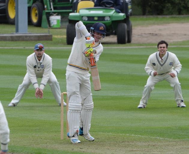 Otago batsman Gregor Croudis defends a ball in his innings yesterday while Auckland slips fieldsmen Robbie O'Donnell (left) and Mark Chapman look on. Photo by Linda Robertson.