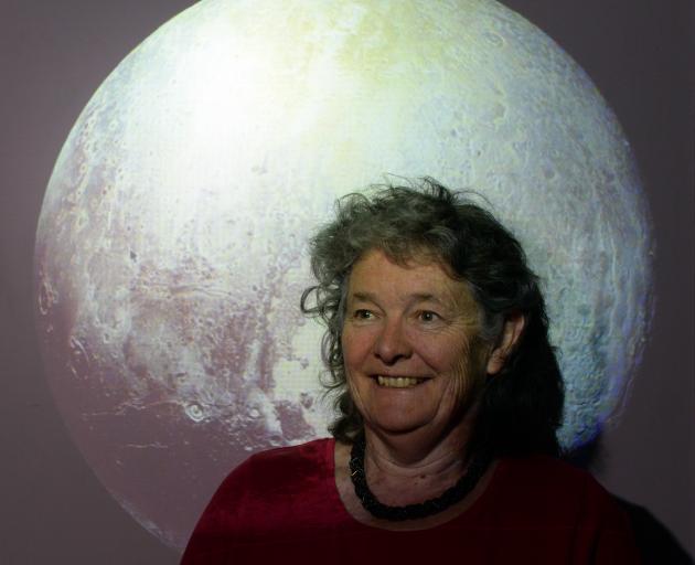 New Horizons co-investigator Fran Bagenal with an image of Pluto, captured by the New Horizons space probe. Photo by Linda Robertson.