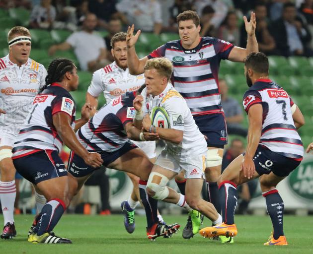 The Chiefs' Damian McKenzie tries to break through the Rebels defence. Photo Getty