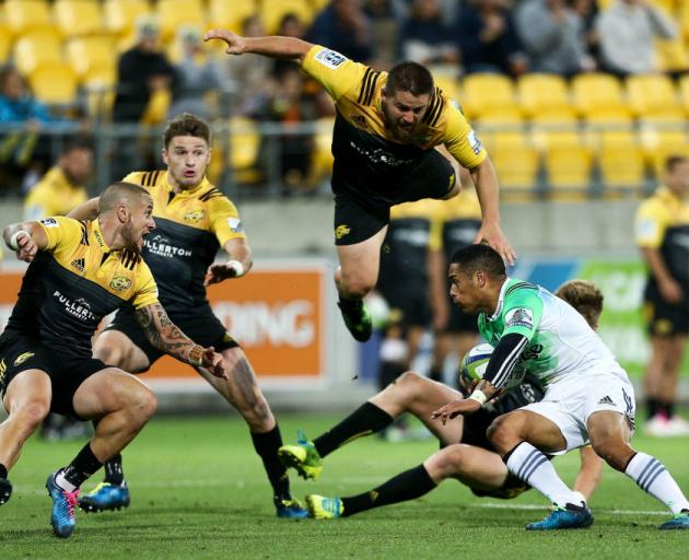 Highlanders halfback Aaron Smith tries to break through the Hurricanes defence. Photo: Getty