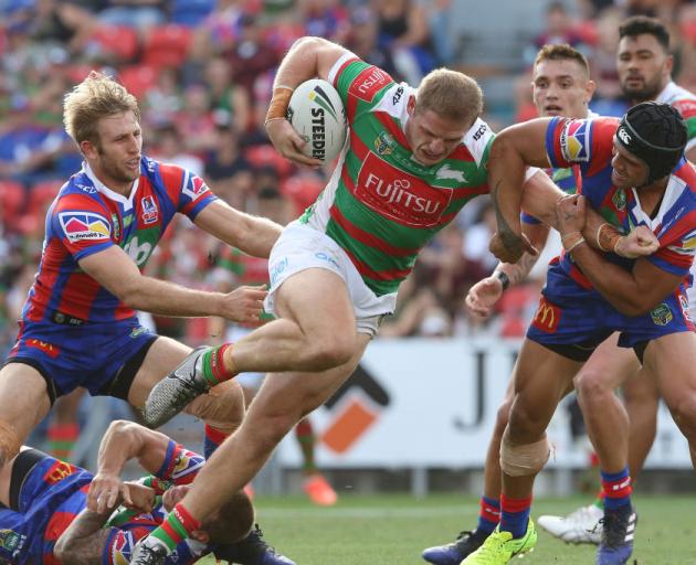 George Burgess of the Rabbitohs is tackled by the Knights defence during the round three match....