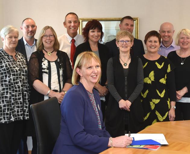 (Front sitting) Otago Community Trust chief executive Barbara Bridger and (from left) donations...