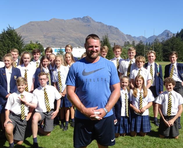 Olympic shot put bronze medallist Tom Walsh pictured with a group of Wakatipu High School athletics and year 10 sports science pupils during training at the school, after his first round in the New Zealand Golf Open at The Hills yesterday. Photo by Tracey