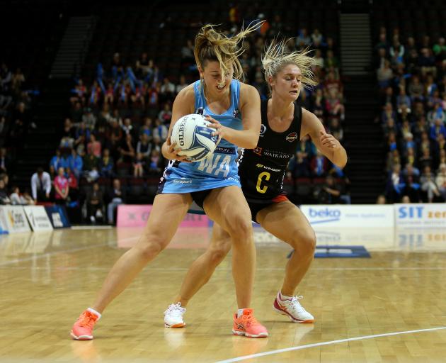 Steel wing attack Gina Crampton (left) catches the ball under pressure from Waikato-Bay of Plenty...