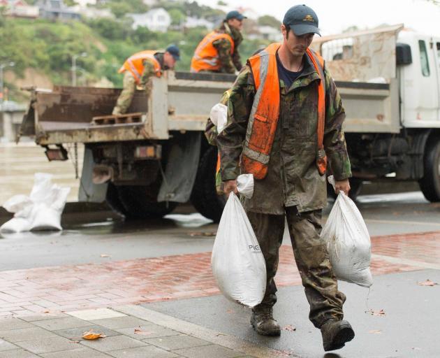 General insurer facing large bill from catastrophe claims. New Zealand Defence Force personnel pictured preparing for floodwaters in wake of the cyclone. Photo: Reuters.