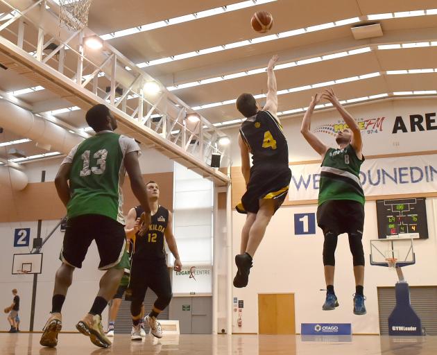 Bombers swingman Steve Robinson shoots over Saints guard James Ross as Damon Cleverley (12) and Henrie Njob-Anti (13) look on at Saturday's pre-season blitz tournament at the Edgar Centre. Photo by Gregor Richardson.