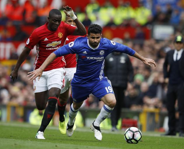 Chelsea's Diego Costa with the ball as Eric Bailly chases him in their game against Manchester...