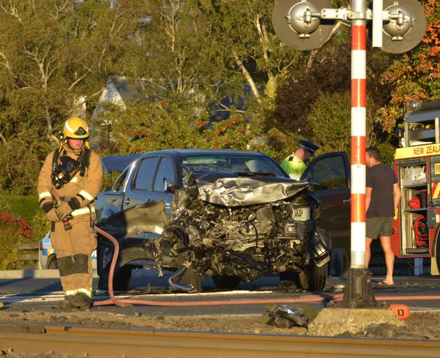 Emergency services inspect a Toyota Hilux which ploughed into a freight train at the intersection of Riccarton Rd East and Gladstone Rd South. Photo by Gerard O'Brien.