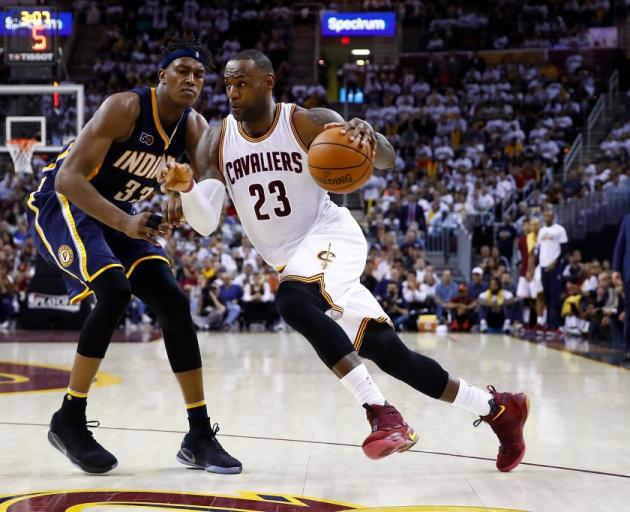 Cleveland Cavaliers forward LeBron James drives past Indiana Pacers forward Myles Turner in the...