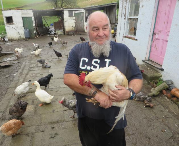 Animal lover and Herbert local Wayne Richardson holds one of his flock. Photo by Shannon Gillies.