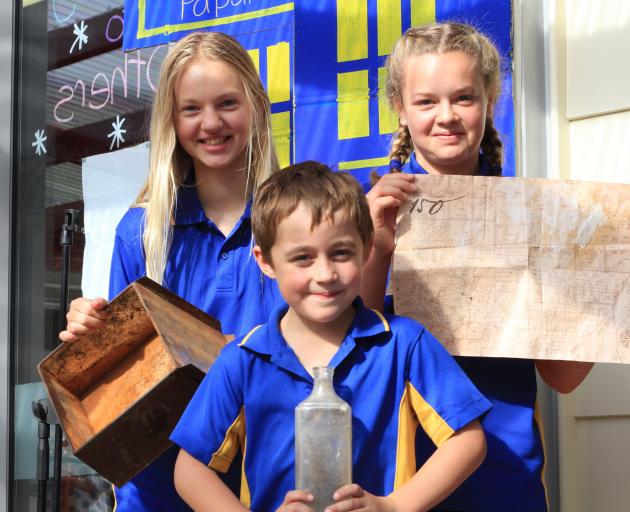 Holding the ``magical'' discovery that inspired a time capsule are Papakaio pupils (from left) Lena Dupu (11), Owen Elliott (8) and Georgie McCarthy (12). Photo by Hamish MacLean.