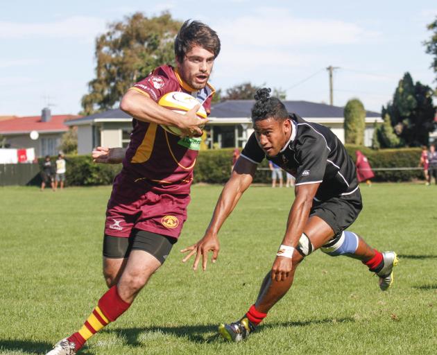 Athletic back  Emanuel Dutack evades Old Boys flanker Filipo Veamatahau at Whitestone Contracting...