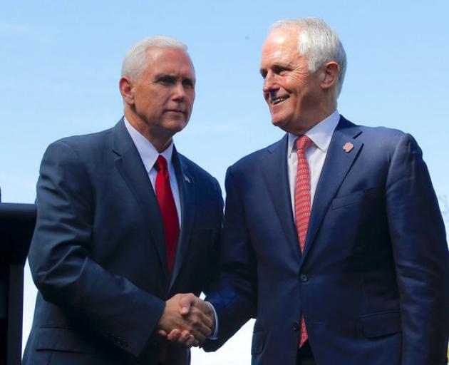 Pence shakes hands with Turnbull after a media conference at Admiralty House in Sydney. Photo: Reuters