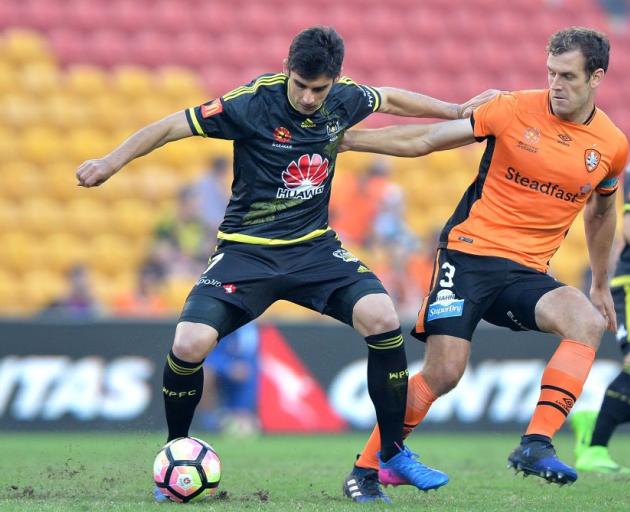 Guilherme Finkler of the Phoenix is pressured by the defence of Luke DeVere of the Roar. Photo:...