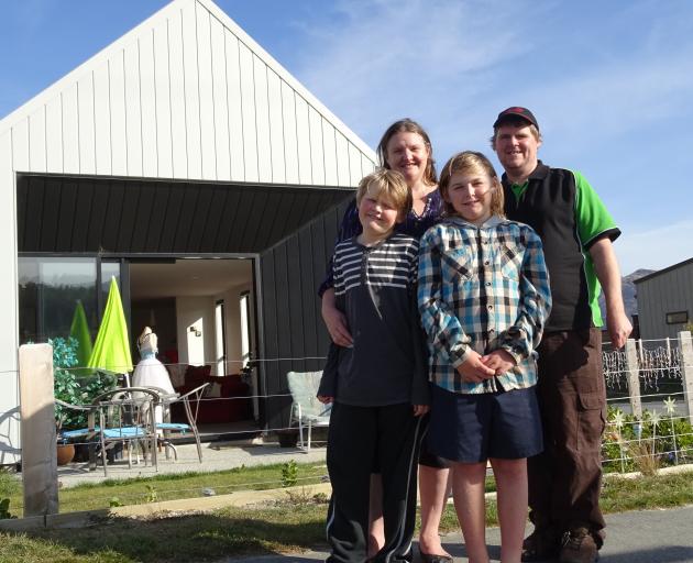 Theresa and Dean Swain and two of their children, Daniel (12, left) and Isaac (11), stand outside their new home yesterday in Shotover Country, part of the Queenstown Lakes Community Housing Trust's 44-lot subdivision. Photo by Tracey Roxburgh.
