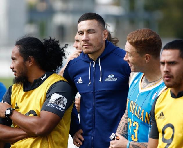 Sonny Bill Williams (middle) at Blues' training wearing a top covering up the sponsors' logos....
