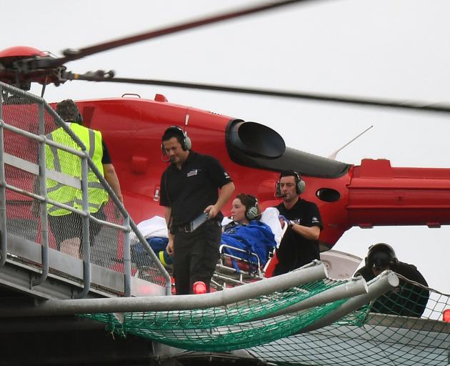 The woman is transferred from the Otago Regional Rescue helicopter to Dunedin Hospital yesterday....