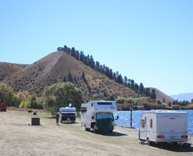 Caravans and camping vehicles parked on the shore of Lake Dunstan at Lowburn, near Cromwell.  Photo from ODT files.