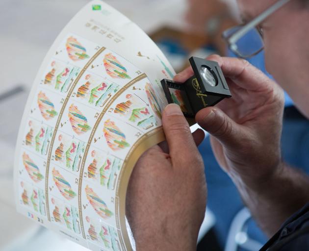 Pride In Print Awards judge Dickon Lentell takes a closer look at the stamps created by Southern Colour Print for the Chunghwa Post Co Ltd. Photo: Supplied.