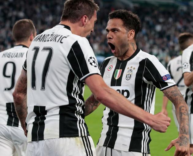 Mario Mandzukic and Dani Alves celebrate a Juventus goal during their Champions League semifinal...