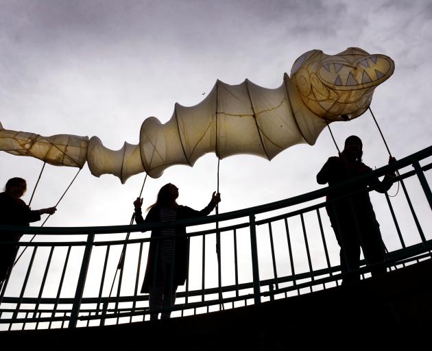 Parading a taniwha lantern in Dunedin yesterday (from left) are  Midwinter Carnival lantern...