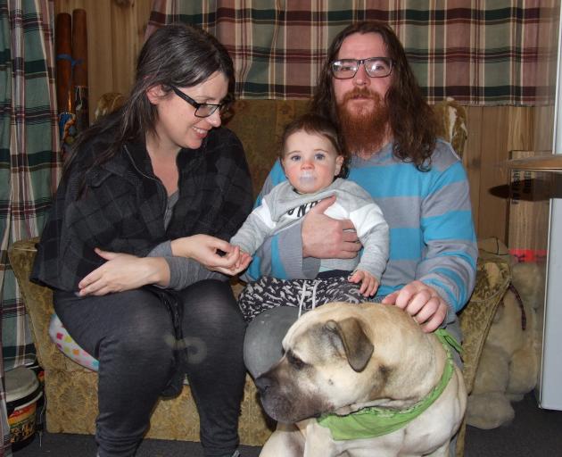 Liz Boyle and Joel Rowlands with their son, Rhythm, and dog Bossco at their rented home at...