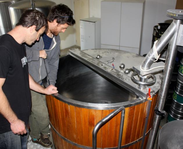 Inspecting the former McDuff’s brewery mash tun from Dunedin are  Oli Boyes and Julian Webster,...