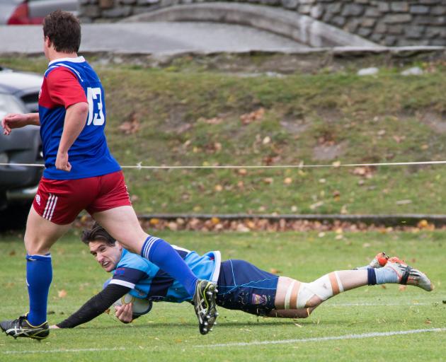 Wakatipu winger Daniel O’Shea dots down in front of Maniototo centre Angus Gibb in  the White...