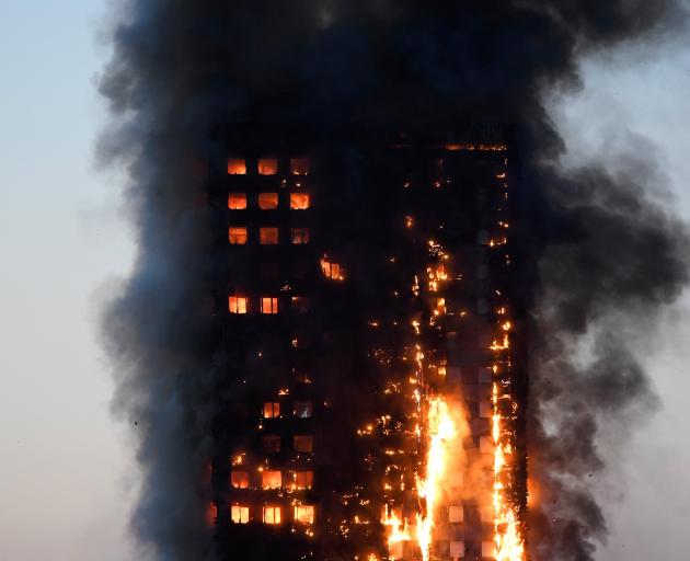 Flames and smoke billow as firefighters attempt to deal with the fire in Grenfell Tower in West London on Wednesday. Photo: Reuters