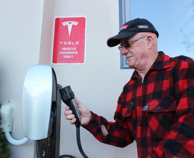 Hawkdun Rise vineyard and accommodation owner John Grant with a new Tesla electric-car charger recently installed on his property, near Alexandra. Photo: Jono Edwards
