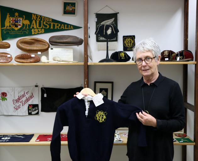 Art+Object rare books manager Pam Plumbly holds the rugby jersey Charlie Saxton wore when Otago won the Ranfurly Shield for the first time in 1935. It will be among 500 items auctioned in Auckland next Thursday. Photo: Supplied