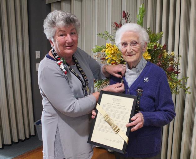 New Zealand Federation of Women's Institute president Kay Hart presents Vi McNutt with her golden honours award for services to the institute on Saturday. Photo: Samuel White