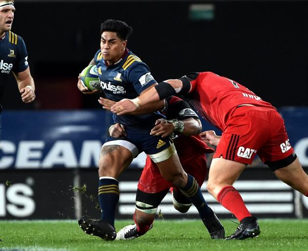 Malakai Fekitoa (centre) tries to evade a tackle against the Crusaders last year. Photo: Peter...