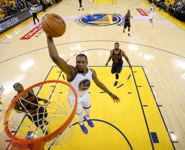 Kevin Durant goes up to slam dunk the ball for the Golden State Warriors in game one of the NBA...