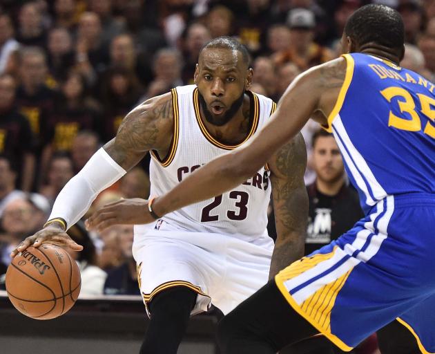 Cavs forward LeBron James takes on Warriors forward Kevin Durant in game three of the NBA Finals....