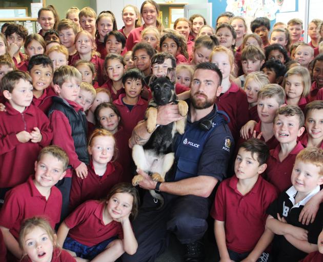 Two primary schools, Stirling and Clutha Valley (above) were visited to answer questions from pupils and educate them about the roles of general purpose police dogs and their handlers. Photo: Samuel White