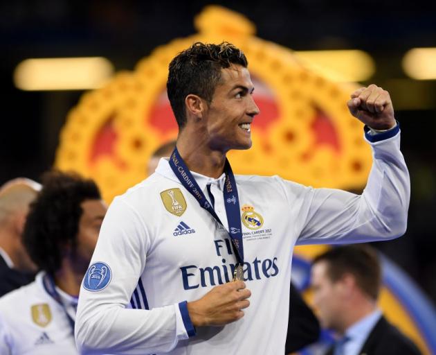 Real Madrid's Cristiano Ronaldo celebrates with his winners medal at the Champions League final....