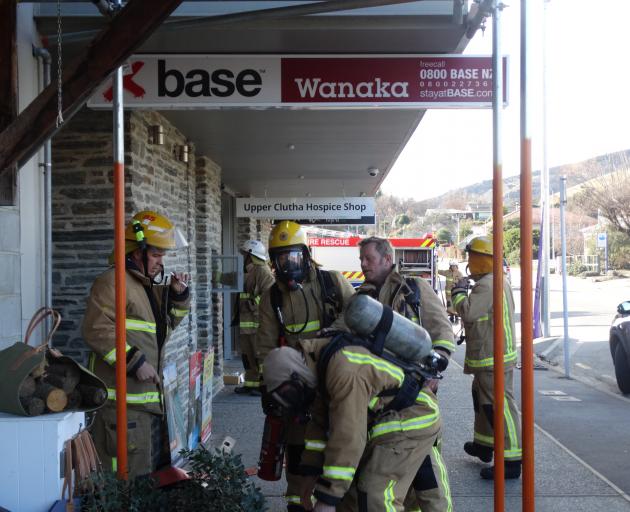 Fire fighters from the Wanaka Volunteer Fire Brigade prepare to enter the Base Backpackers in Wanaka this afternoon. Photo: Tim Miller Fire fighters from the Wanaka Volunteer Fire Brigade prepare to enter the Base Backpackers in Wanaka this afternoon. Photo: Tim Miller