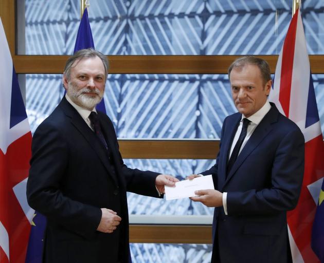 Britain's permanent representative to the European Union Tim Barrow (left) delivers British Prime Minister Theresa May's Brexit letter in notice of the UK's intention to leave the bloc, under Article 50 of the EU's Lisbon Treaty, to EU Council President D
