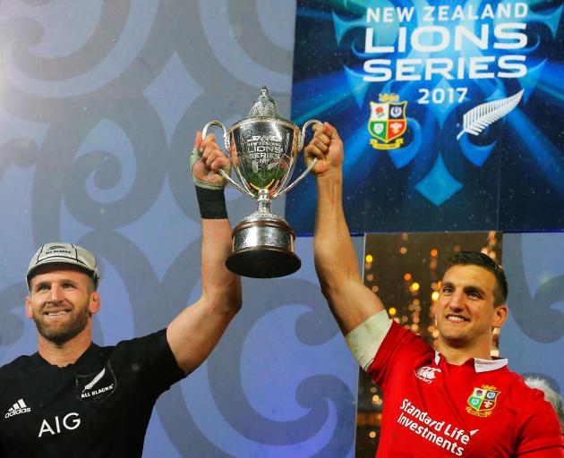 All Black captain Kieran Read (left) and Lions captain Sam Warburton jointly hoist the winner's trophy after the third test and the series were drawn in Auckland on Saturday night. Photo: Reuters.