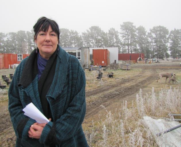 Adrienne Lamb, of Letts Gully Rd, near Alexandra, braves the cold after a power outage yesterday...